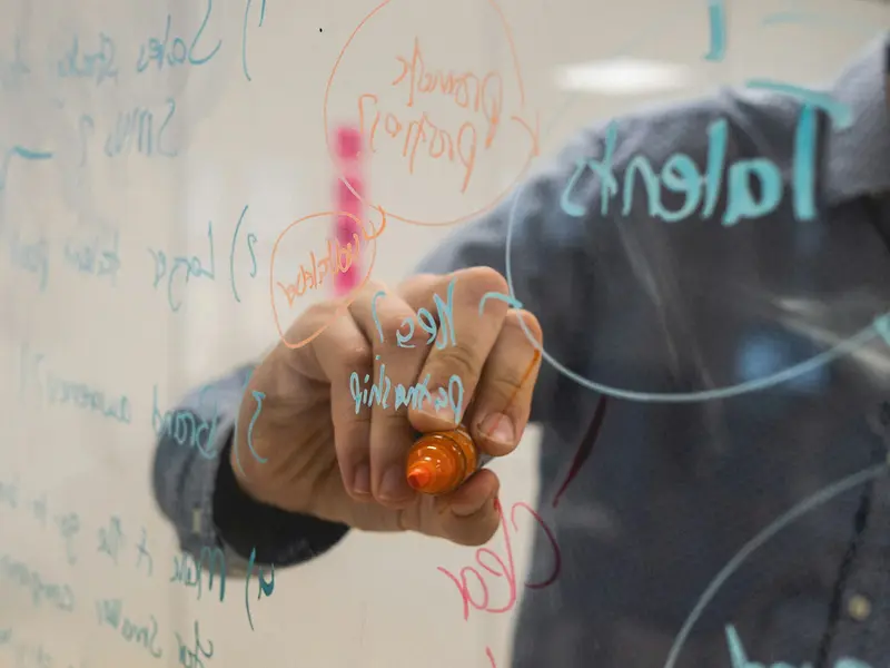 a diagram drawn on a glass whiteboard